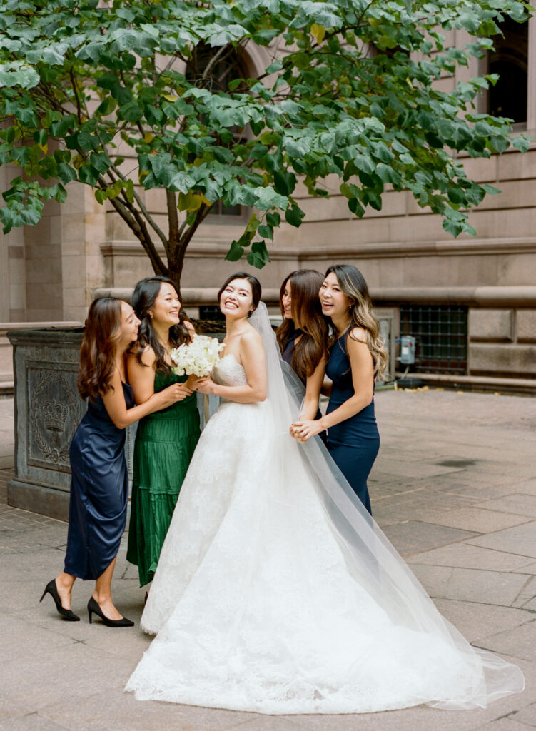 Bride and bridesmaids smiling on wedding day 