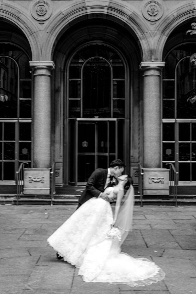 Bride and groom kissing in Lotte palace courtyard in black and white 