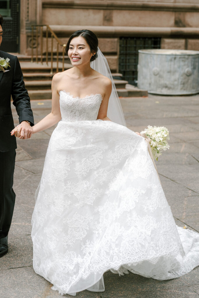 Bride in lace strapless Monique Lhuillier wedding gown 