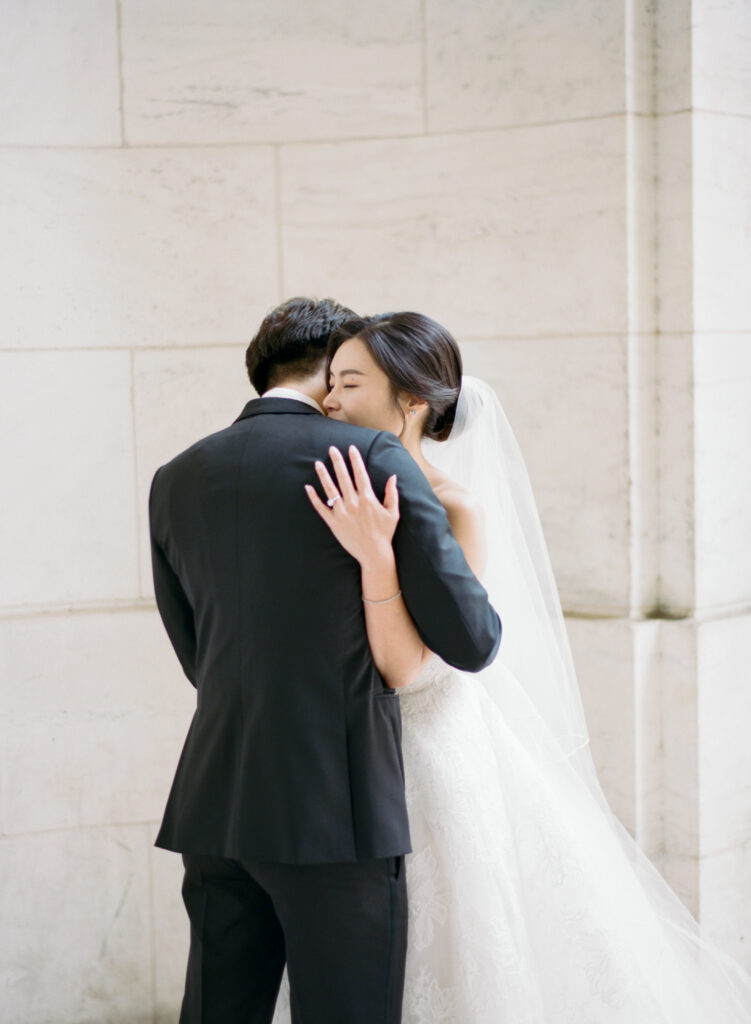 Bride and groom hugging at New York Public Library