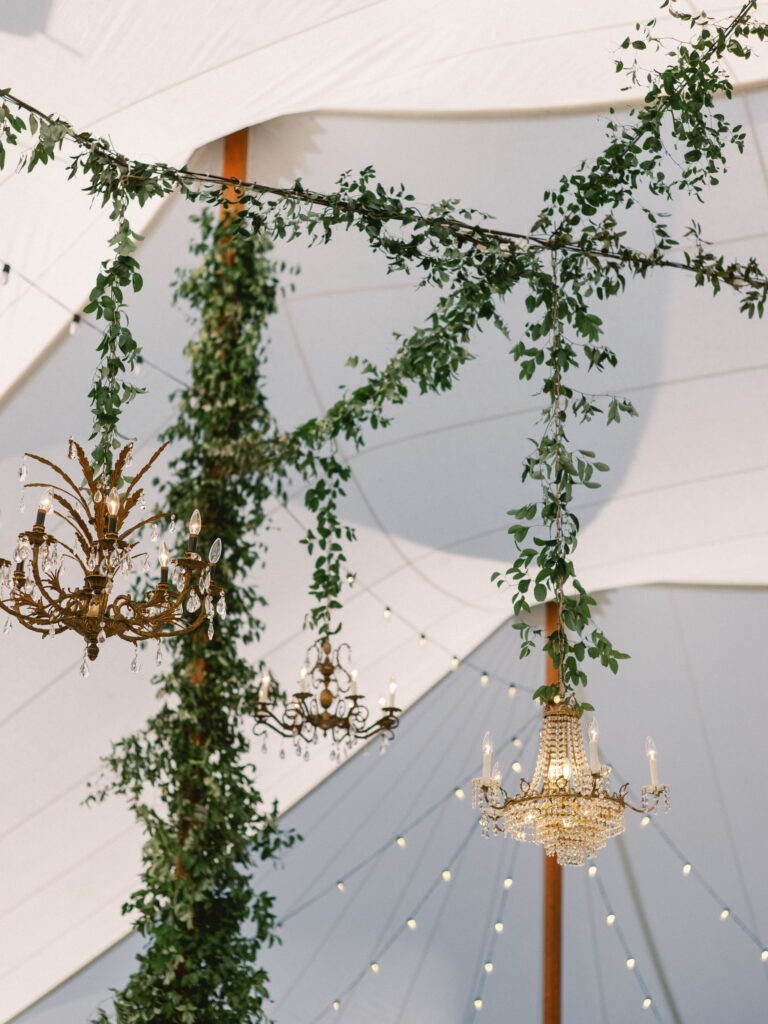 wedding chandeliers and greenery at tented wedding outdoor