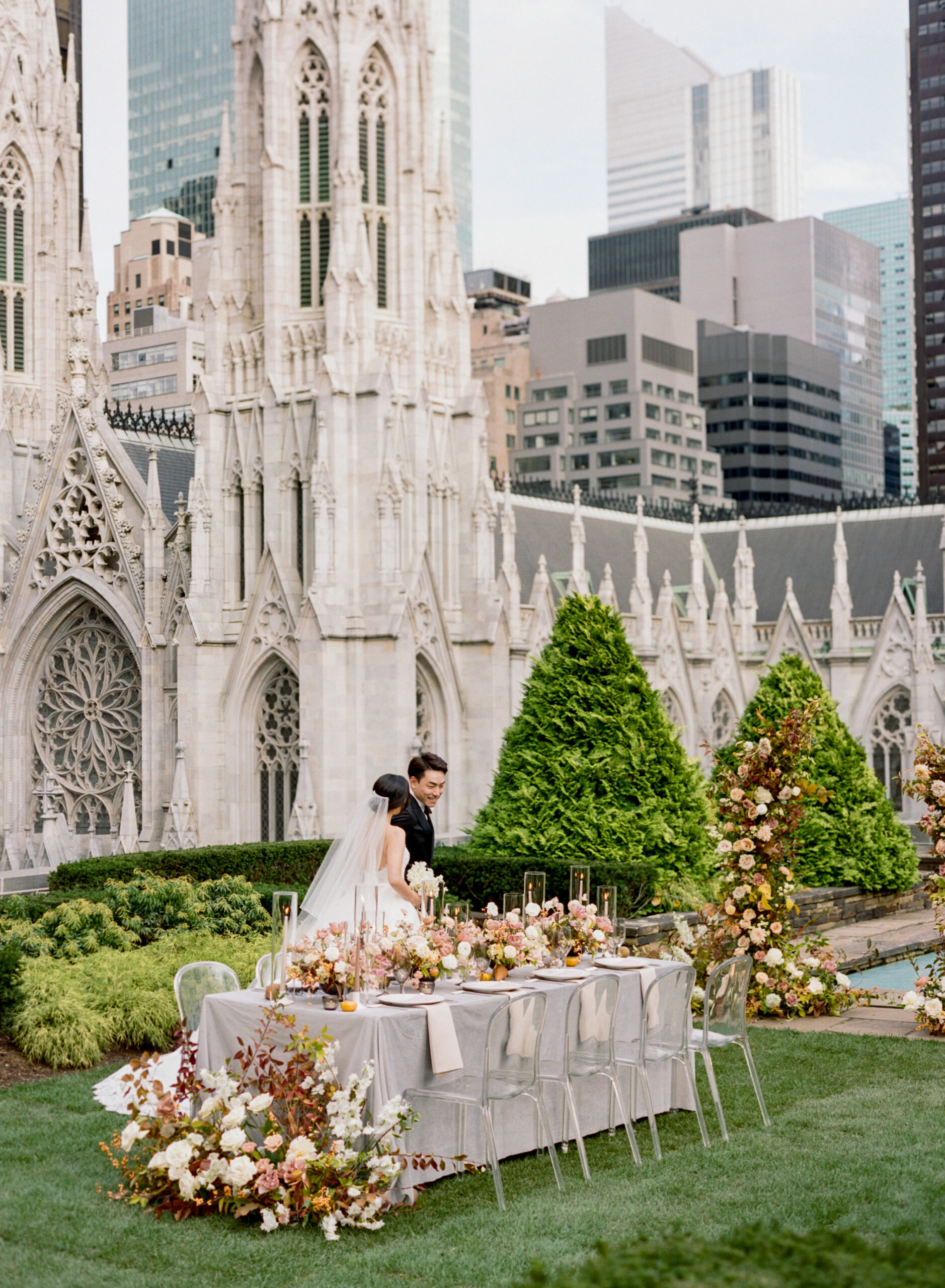Bride and groom walking around their wedding table outdoors at NYC rooftop wedding venue 620 Loft & Garden