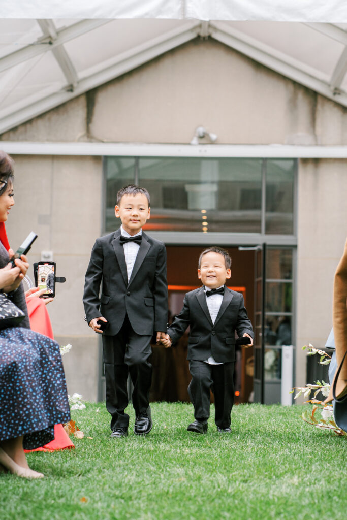 Ring bearers processional at wedding ceremony in tuxes 