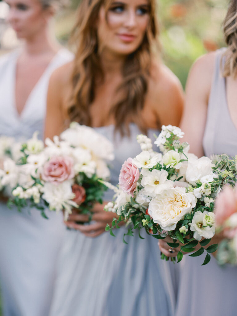 closeup of bridesmaids bouquets with white garden roses and mauve rose 