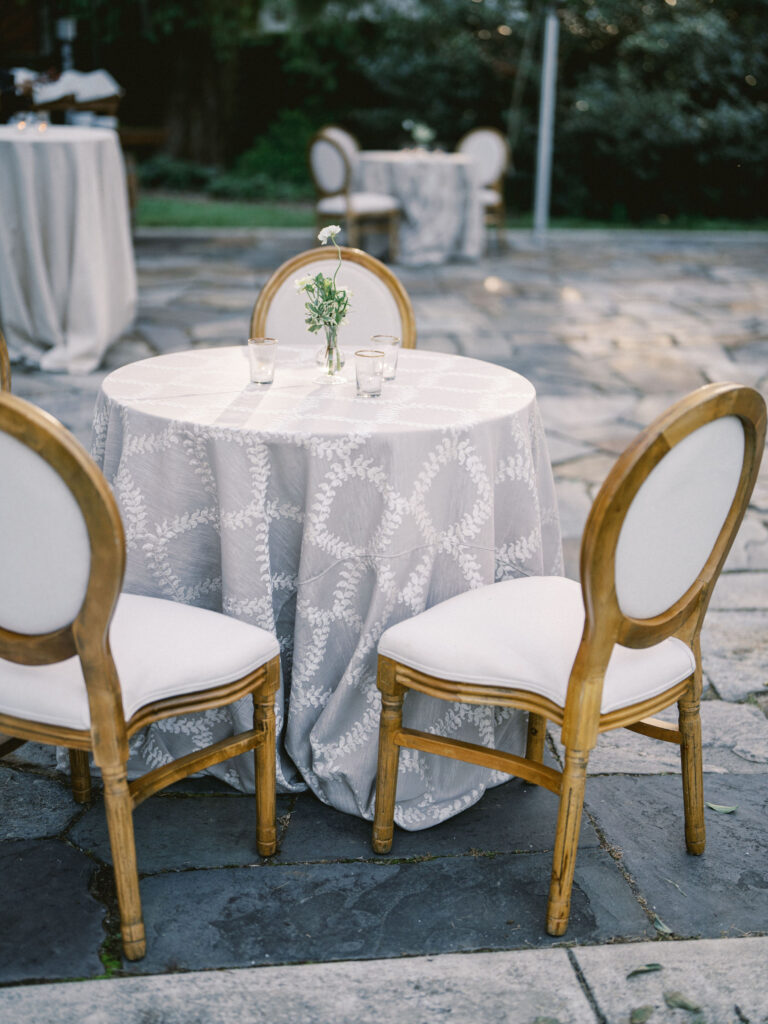 kings chairs with neutral patterned linen at cocktail hour table 