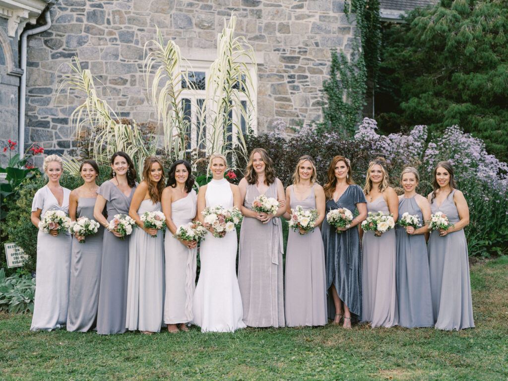 bridesmaids in mismatched long blue dresses with neutral bouquets at cylburn arboretum in baltimore 