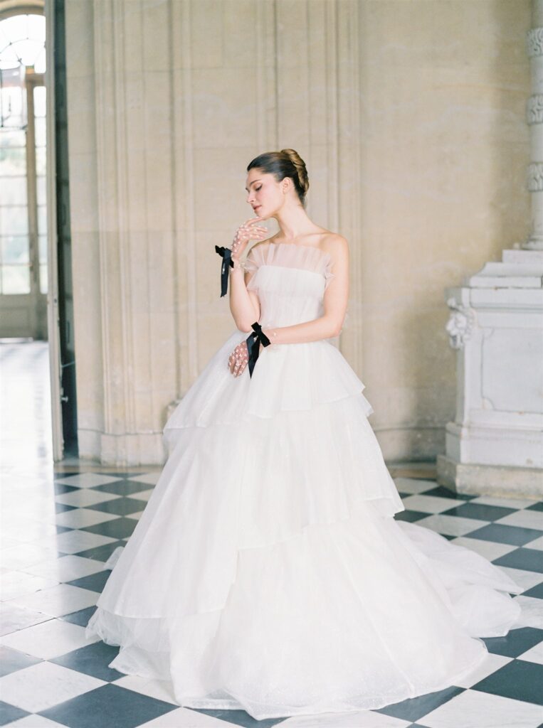 Bridal portrait in strapless white tulle wedding gown by Dylan Parienty
