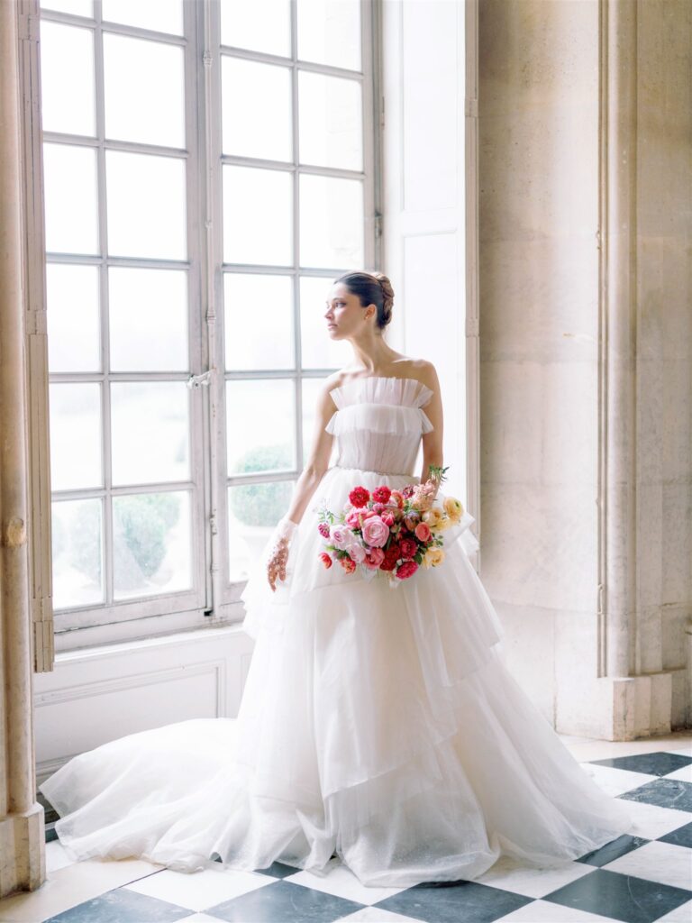 bridal portrait in layered tulle gown by dylan parienty with bright pink bridal bouquet 