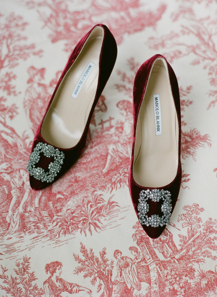 red velvet burgundy manolo blahnik bridal shoes on red french toile fabric wedding styling by east made co 