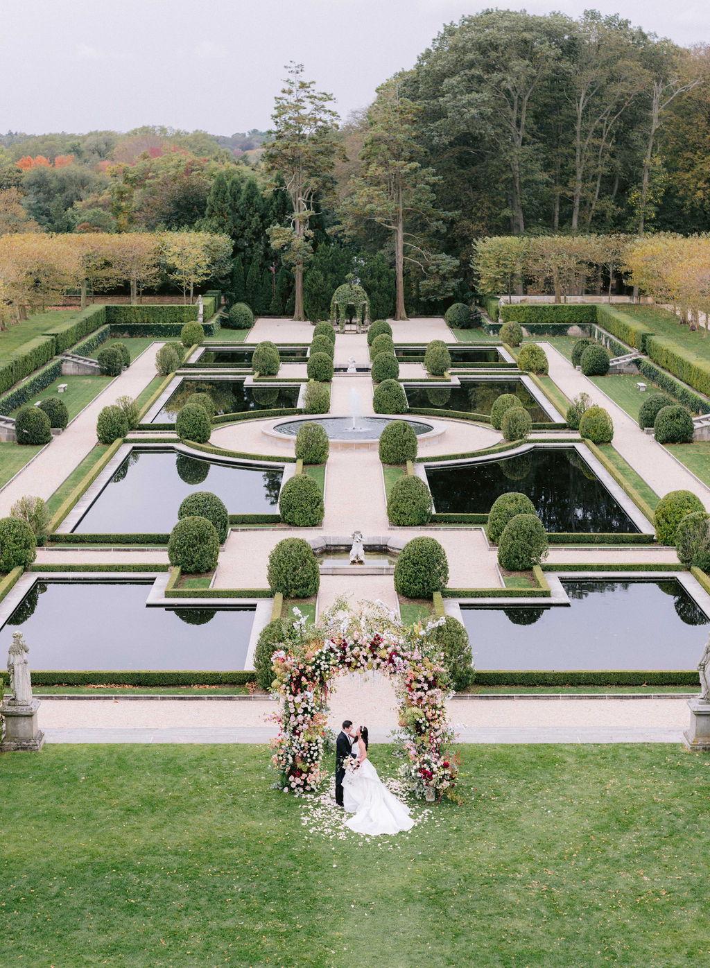 Bride and groom at Oheka Castle Wedding in French gardens US luxury wedding venue