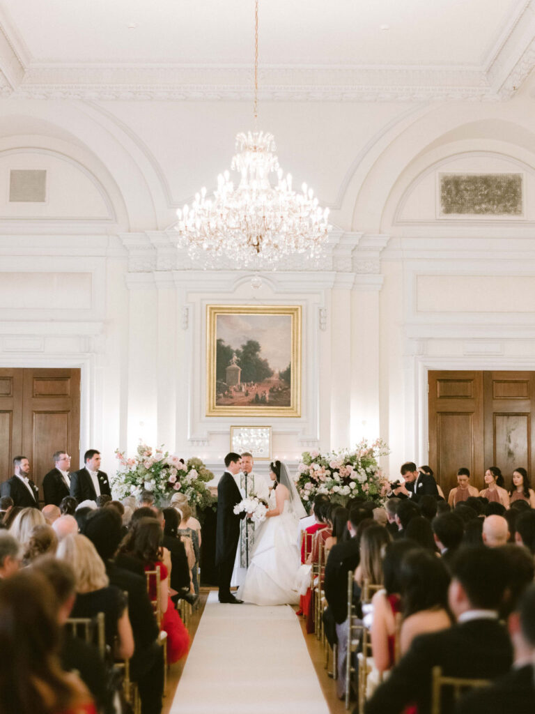 wedding ceremony indoors at oheka castle with guests 