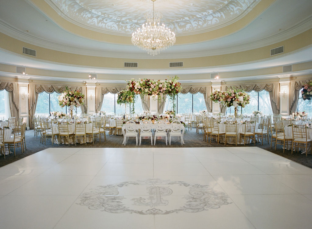 oheka castle ballroom wedding design with ceiling textured lighting wash and custom monogram dance floor design by east made co nyc wedding planner 