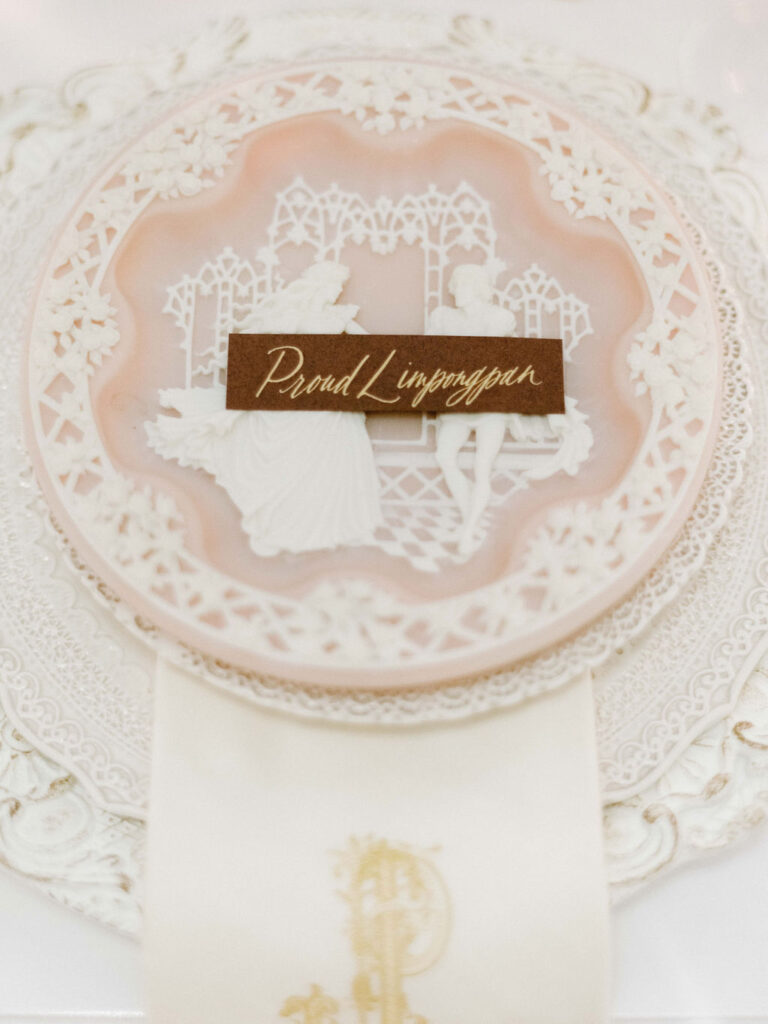 calligraphy place card on burgundy paper on romeo and juliet plate 
