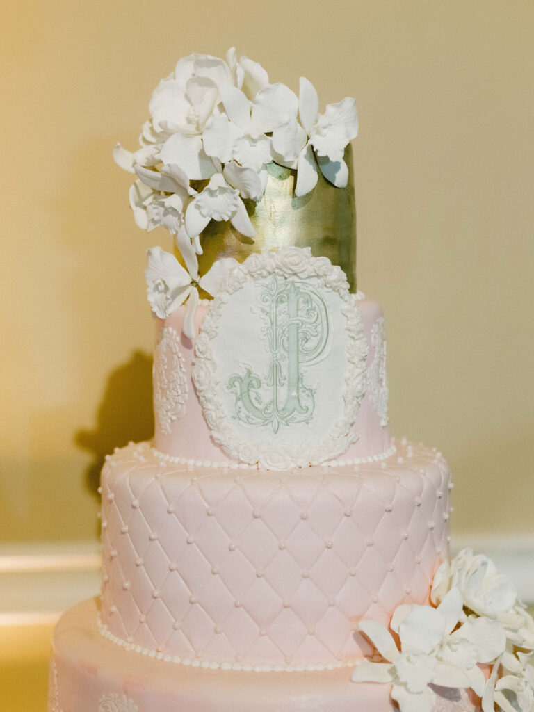 custom logo on pink wedding cake with white orchid flowers 