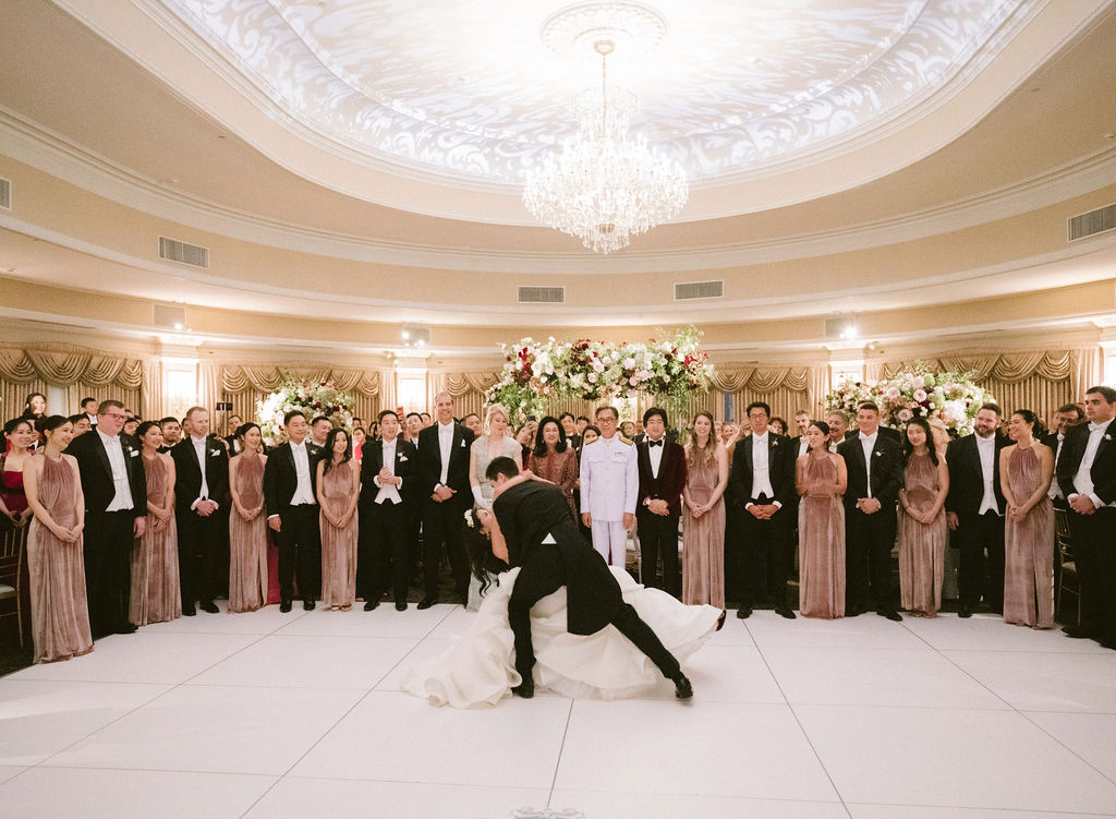 bride and groom dip during first dance at wedding 