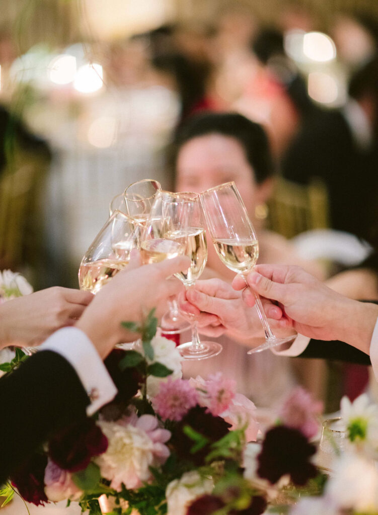 guests clinking champagne flutes 