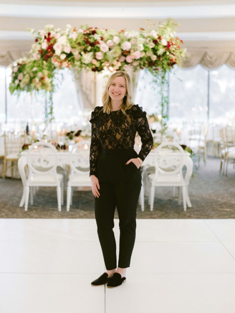 luxury wedding planner elizabeth gopal of east made co in front of ballroom design at oheka castle 