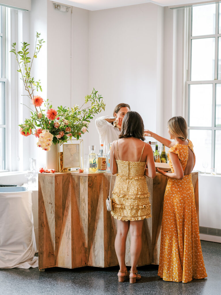 wedding guests at wooden zig zag bar modern 