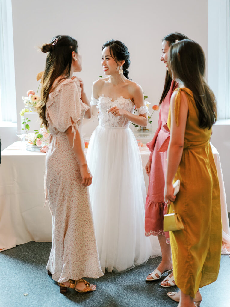 bride talking to her friends during cocktail hour 